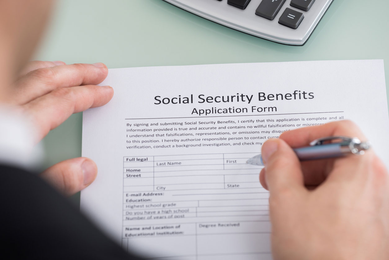 image of man filling out a Social Security benefits application form 